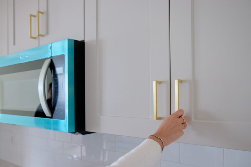 Womans hand on kitchen cabnet
