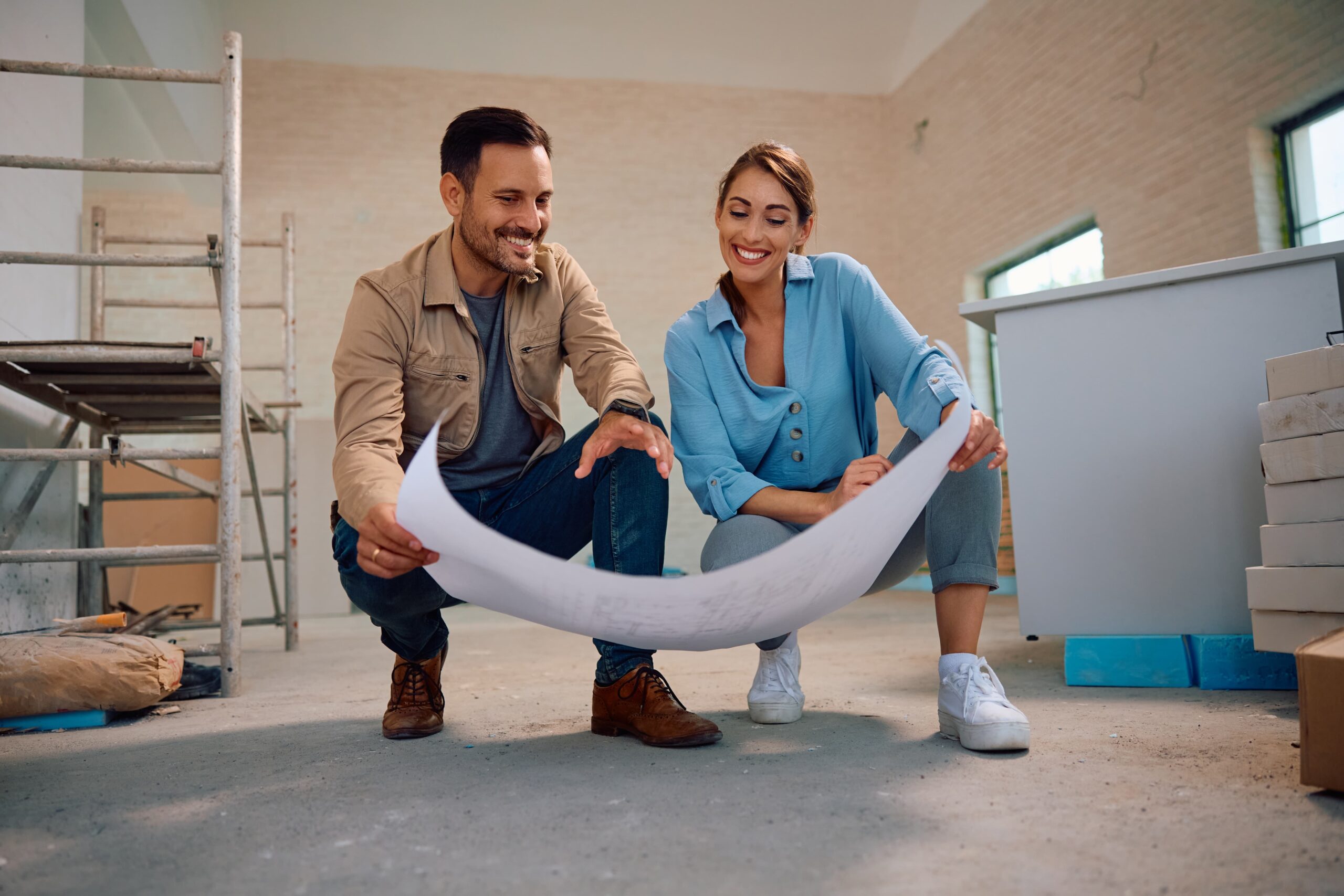Happy couple looking at plans for their new home